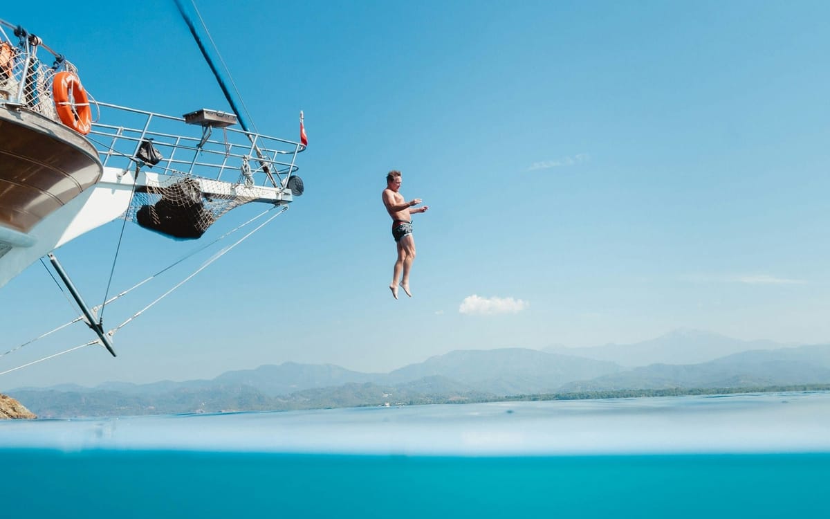 A man jumping into the water off a boat. Some users are leaving GitHub for opensource platforms.