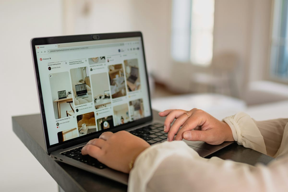 A person browses Pinterest on a laptop