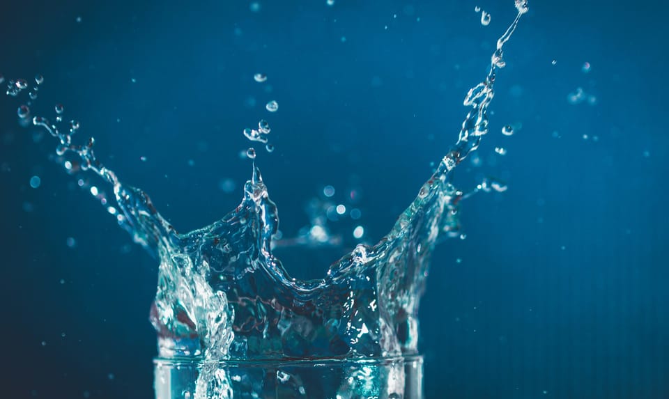 A glass of water splashes, spraying drops of water. DripDropper is a maware loader installed via an Apache ActiveMQ vulnerability.