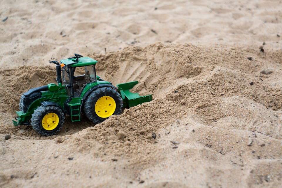 A toy tractor in a sandbox. The UK Government will let companies test AI tools in regulatory sandboxes.