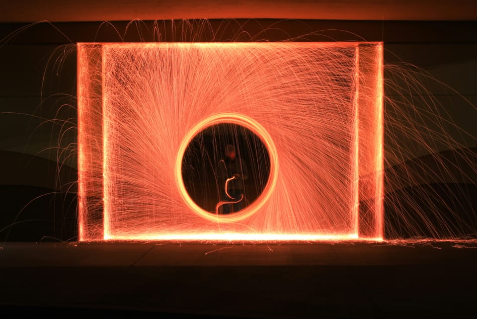 A person stood in the centre of a block of light made to look like a portal using long-exposure photography. Startup Portal26 raised nine million dollars this week.